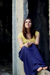 Portrait of a beautiful young woman sitting outdoors