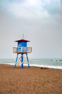 Mediterranean beach with vintage and lonely lifeguard wooden tower, de la cala beach, malaga, spain