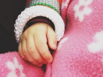 Close-up of baby hand on blanket