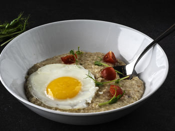 Parmesan oatmeal and scrambled eggs on the table