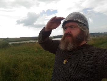 Man standing on field against sky