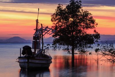 Boat in calm sea against scenic sky