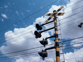 Low angle view of signal against sky