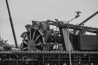 Low angle view of industry against clear sky