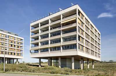 Modern apartment block placed on columns to minimize impact on the dune landscape in hook of holland