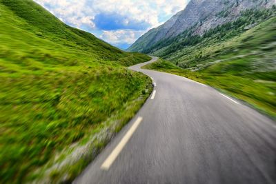 On board motion effect riding on winding road in natural landscape