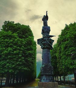 Low angle view of statue against sky in city
