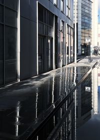 Reflection of buildings on wet glass window