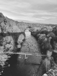 High angle view of river amidst trees against sky