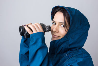 Portrait of young woman against white background