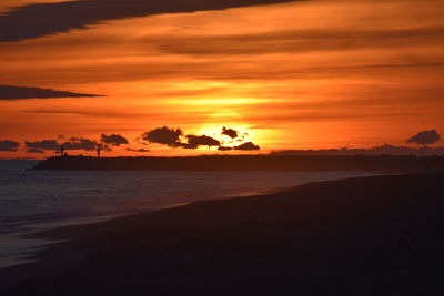 Scenic view of sea against romantic sky at sunset