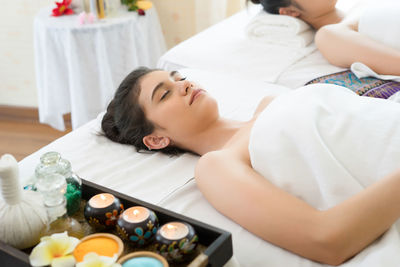 Young woman relaxing on massage table in spa