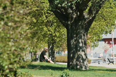 Side view of a man sitting in park