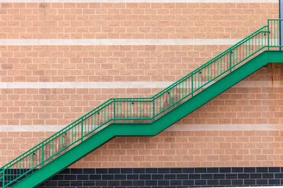 Spiral staircase against brick wall