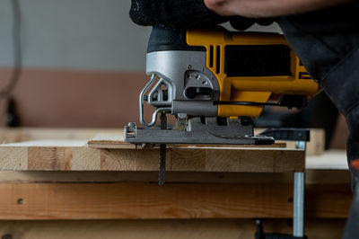 Cropped hands of man working in workshop