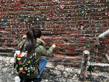 Woman decorating gum wall