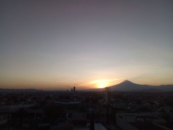 View of town against sky during sunset