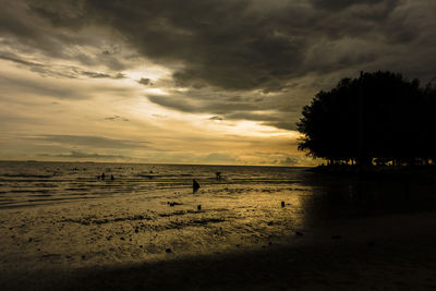 Scenic view of beach against sky during sunset