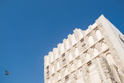 Low angle view of building against blue sky