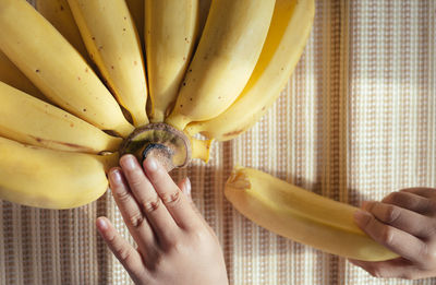 Cropped image of hands talking banana