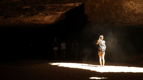 Woman standing in cave