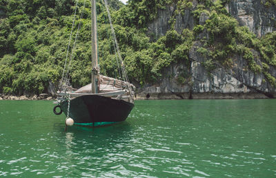 Nautical vessel on halong bay by mountain