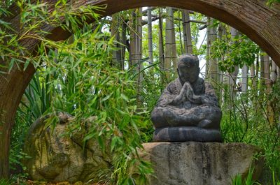 Statue against plants in garden