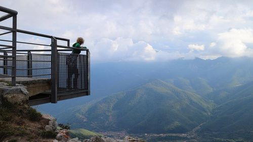 Scenic view of mountains against cloudy sky