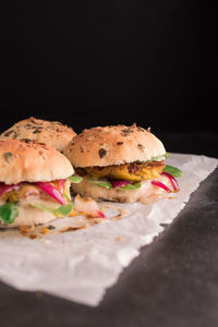 Close-up of burger against black background