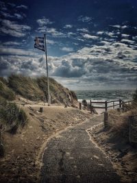 Road by sea against sky