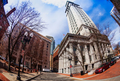 Street amidst buildings against sky in city