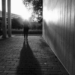 Full length of woman standing on steps