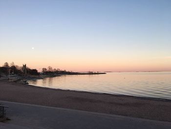 Scenic view of sea against clear sky during sunset