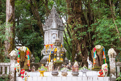 Statue against trees and building