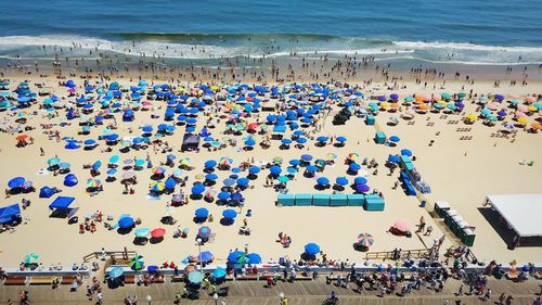 High angle view of people at beach against sky