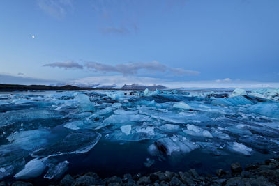 Scenic view of frozen landscape against sky