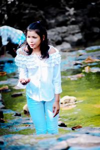 Full length of girl standing in water