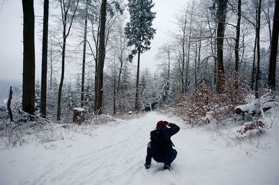 Man walking on snow covered landscape