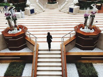 Woman walking on steps in city