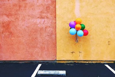 Colorful balloons hanging on wall