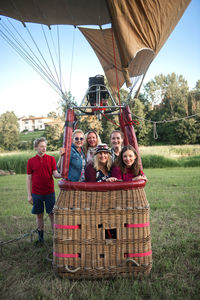 Portrait of friends standing in hot air balloon