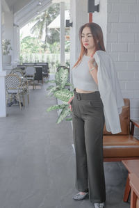 Full length of woman standing on chair