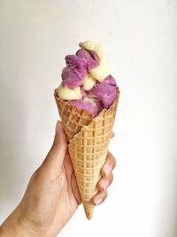 Close-up of hand holding ice cream cone