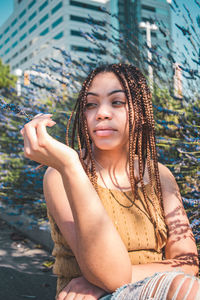 Portrait of beautiful young woman looking away