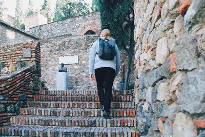 Rear view of man standing against wall