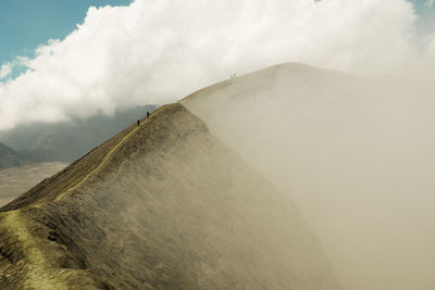 Scenic view of mountain against cloudy sky