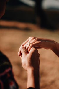 Midsection of couple holding hands