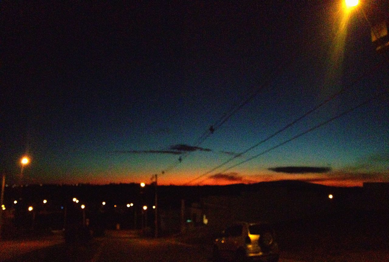 illuminated, night, street light, lighting equipment, sunset, electricity, sky, transportation, silhouette, dusk, road, power line, street, built structure, dark, light - natural phenomenon, connection, electric light, no people, copy space