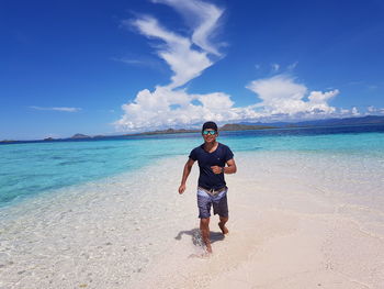 Full length of man on beach against sky