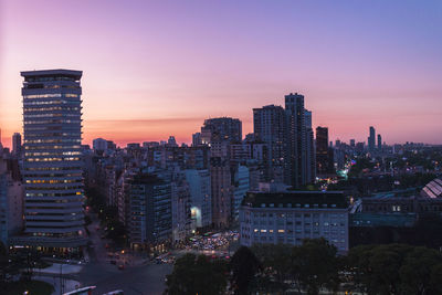 Illuminated cityscape against sky at night